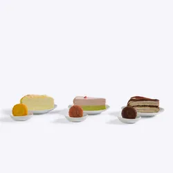 Three slices of Lady M crepe cake, each paired with a mooncake of the same flavor on a white plate.