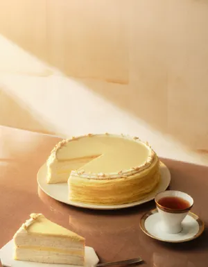 Warm image of Lady M's Jasmine Calamansi Mille Crêpes with a slice removed.