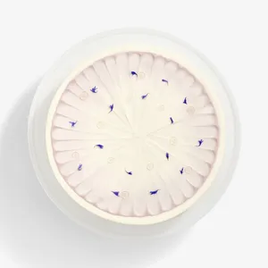 A top-down shot of a Lady M Taro Mochi Cream Cake set on top a white cake stand.