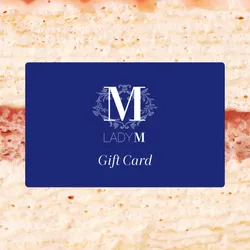 Image of Lady M Gift Card over a close-up shot of a Lady M crepe cake.