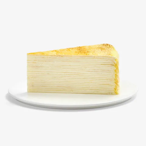 A Lady M Gluten-Free Signature Mille Crêpes slice on top a white round plate.