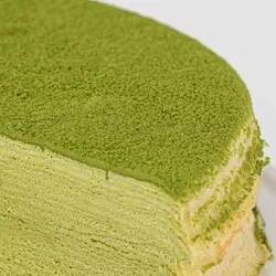 Detail shot of Lady M's Gluten-Free Green Tea Mille Crêpes. Layers of crêpe, cream, and matcha powder.