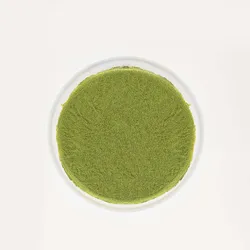 A top-down shot of a Lady M Gluten-Free Green Tea Mille Crêpes on top a white cake stand.