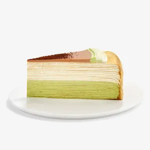 A Lady M Coffee Matcha Mille Crêpes slice on top a white round plate.