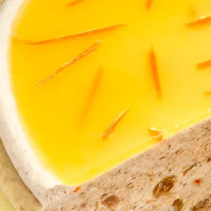 Close-up of a Lady M Carrot Cake Mille Crêpes. Layers of crêpe, cream, cake crumble, and jelly.