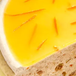 Close-up of a Lady M Carrot Cake Mille Crêpes. Layers of crêpe, cream, cake crumble, and jelly.