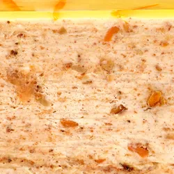 A Lady M Carrot Cake Mille Crêpes detail shot. Layers of crêpe, cream, cake crumble, and jelly.