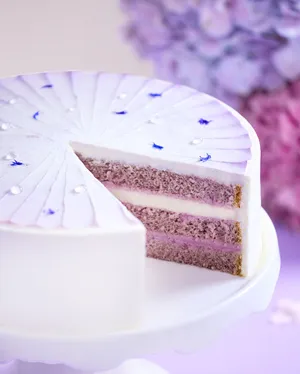 Lady M's Taro Mochi Cream Cake against a lilac background
