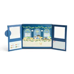 An open Lady M 2025 Holiday Crêpe Biscuit Tasting Set.