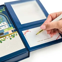 A close up of an open Lady M 2025 Holiday Crêpe Biscuit Tasting Set.