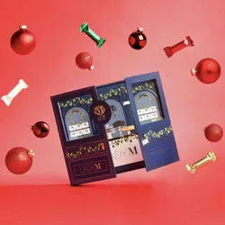 Lady M's Holiday Crepe Biscuit Tasting Set with ornaments and biscuits on a red background.