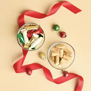 A top down shot of Lady M's Holiday Mini Crêpe Biscuits on a beige background.