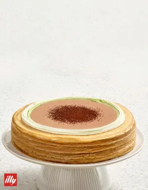 Lady M's illy Coffee Matcha Mille Crêpes on a stone surface with the illy logo.