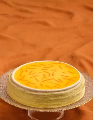 Lady M's Carrot Cake Mille Crêpes on a dusty orange tablecloth.