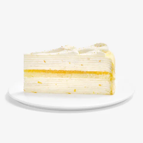 A slice of Lady M's Orange Mille Crepes on a white cake plate.