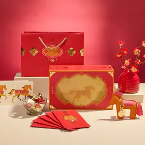 A Lady M 2026 Year of the Horse Gift Set on top of a beige table with a red background.