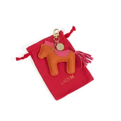 Lady M's 2026 Year of the Horse Vegan Leather Bag Charm with red dust bag.