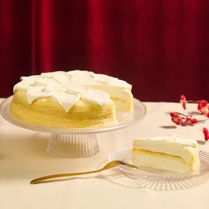 Lady M’s Orange MC sliced and served on a glass plate against a red fabric backdrop.