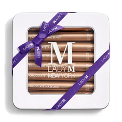 Image of Lady M's Chocolate Hazelnut Crêpe Biscuits with a logo on the top lid and a blue ribbon.