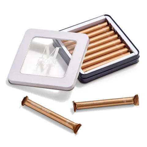 Lady M's Chocolate Hazelnut Crêpe Biscuits in an open tin with two biscuits outside