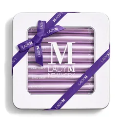 Lady M's Earl Grey Crêpe Biscuits with a logo on the top lid and a blue ribbon.