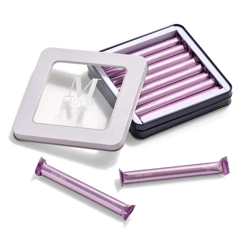 Lady M's Earl Grey Crêpe Biscuits in an open tin with two biscuits outside