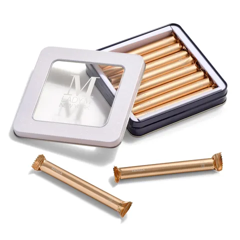 Lady M's Vanilla Crêpe Biscuits in an open tin with two biscuits outside