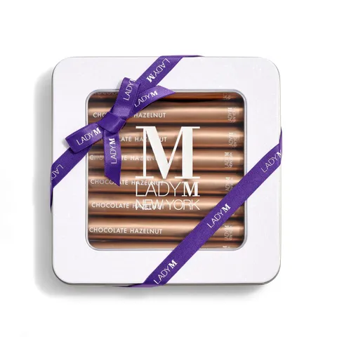 Image of Lady M's Chocolate Hazelnut Crêpe Biscuits with a logo on the top lid and a blue ribbon.