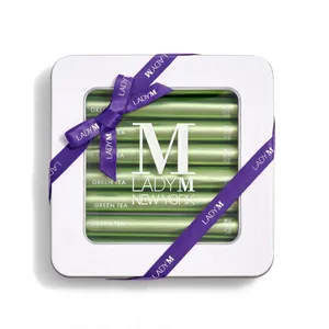 Lady M's Green Tea Crêpe Biscuits with a logo on the top lid and a blue ribbon.