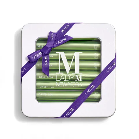 Lady M's Green Tea Crêpe Biscuits with a logo on the top lid and a blue ribbon.