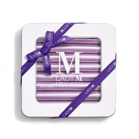 Lady M's Earl Grey Crêpe Biscuits with a logo on the top lid and a blue ribbon.