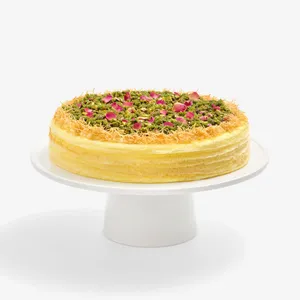 Lady M's Baklava Mille Crêpes cake topped with pistachios, rose petals, and crisp kataifi.