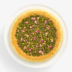 Top-down view of Lady M's Baklava Mille Crêpes with pistachios, rose petals, and kataifi.