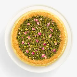 Top-down view of Lady M's Baklava Mille Crêpes with pistachios, rose petals, and kataifi.