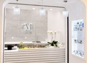 Lady M's Tangram boutique with marble walls, chandeliers, cakes, and bon bons.