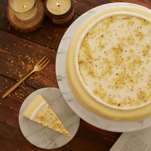 Osmanthus Mille Crêpes cake with slice removed, showcasing delicate handcrafted crêpe layers and floral glaze