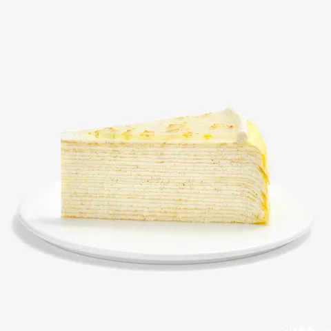 Slice of Osmanthus Mille Crêpes showcasing delicate handcrafted layers and glossy floral osmanthus glaze