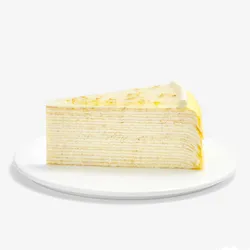 Slice of Osmanthus Mille Crêpes showcasing delicate handcrafted layers and glossy floral osmanthus glaze