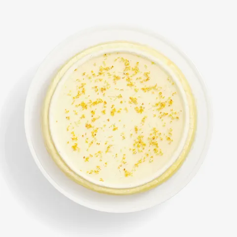 Top-down view of Osmanthus Mille Crêpes with glossy floral glaze and delicate osmanthus blossoms
