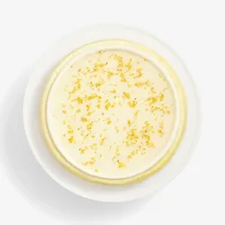 Top-down view of Osmanthus Mille Crêpes with glossy floral glaze and delicate osmanthus blossoms