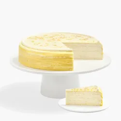 Osmanthus Mille Crêpes whole cake and slice showcasing delicate floral layers and glossy glaze finish