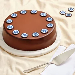 World Cup Checkers cake topped with soccer ball chocolates on a marble cake stand.