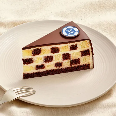 World Cup Checkers cake slice featuring chocolate and vanilla checkerboard layers on a dessert plate.