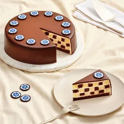 Slice of World Cup Checkers cake revealing checkerboard layers beneath chocolate ganache.