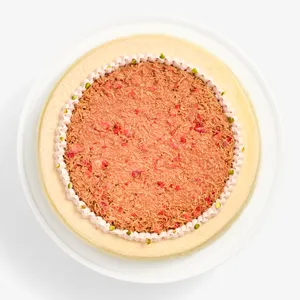 Overhead view of Dubai Strawberry Mille Crêpes topped with strawberry kataifi and pistachio pieces.