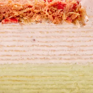 Close-up cross-section of Dubai Strawberry Mille Crêpes showing delicate layers of cream and crêpes.