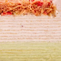 Close-up cross-section of Dubai Strawberry Mille Crêpes showing delicate layers of cream and crêpes.