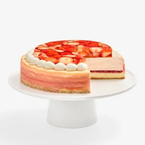 Whole Oishii Berry Trois Mille Crêpes cake with slice cut, on white cake stand