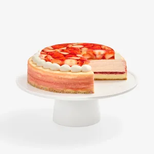 Whole cake with one slice removed, showing crêpe layers, on white cake stand