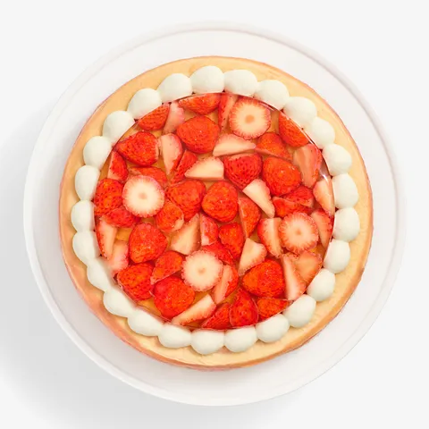 Overhead view of cake showing strawberry topping and whipped cream border
